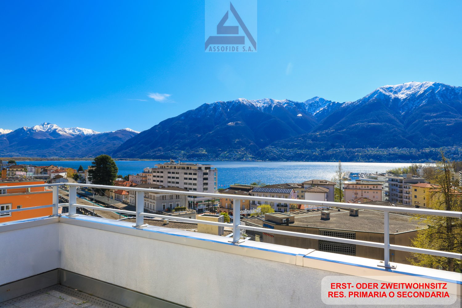 Building with balcony, overlooking mountains and lake