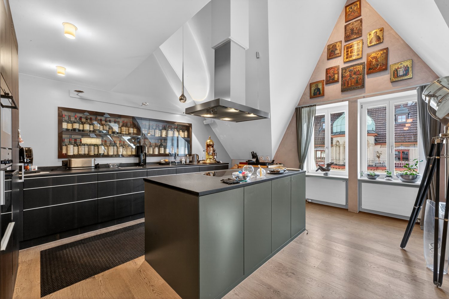 modern kitchen with island, wine rack, large windows, wooden floor
