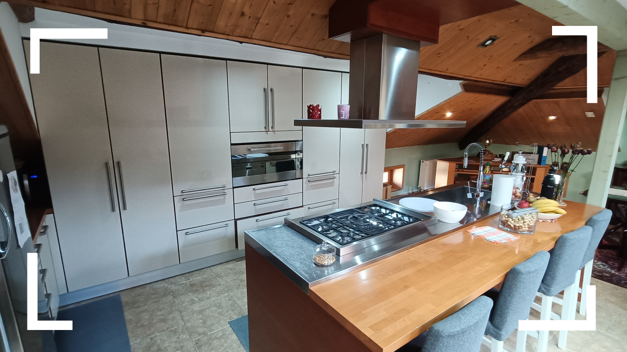 White kitchen cabinets, stainless steel appliances, wooden countertop, gas stove with chimney hood