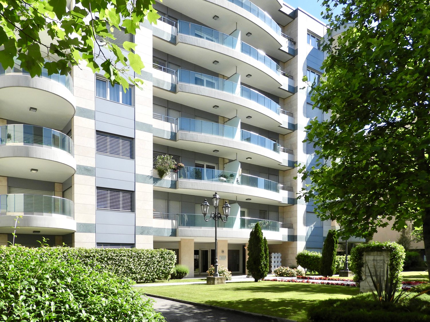 modern apartment building, 6 floors, balconies, landscaped front