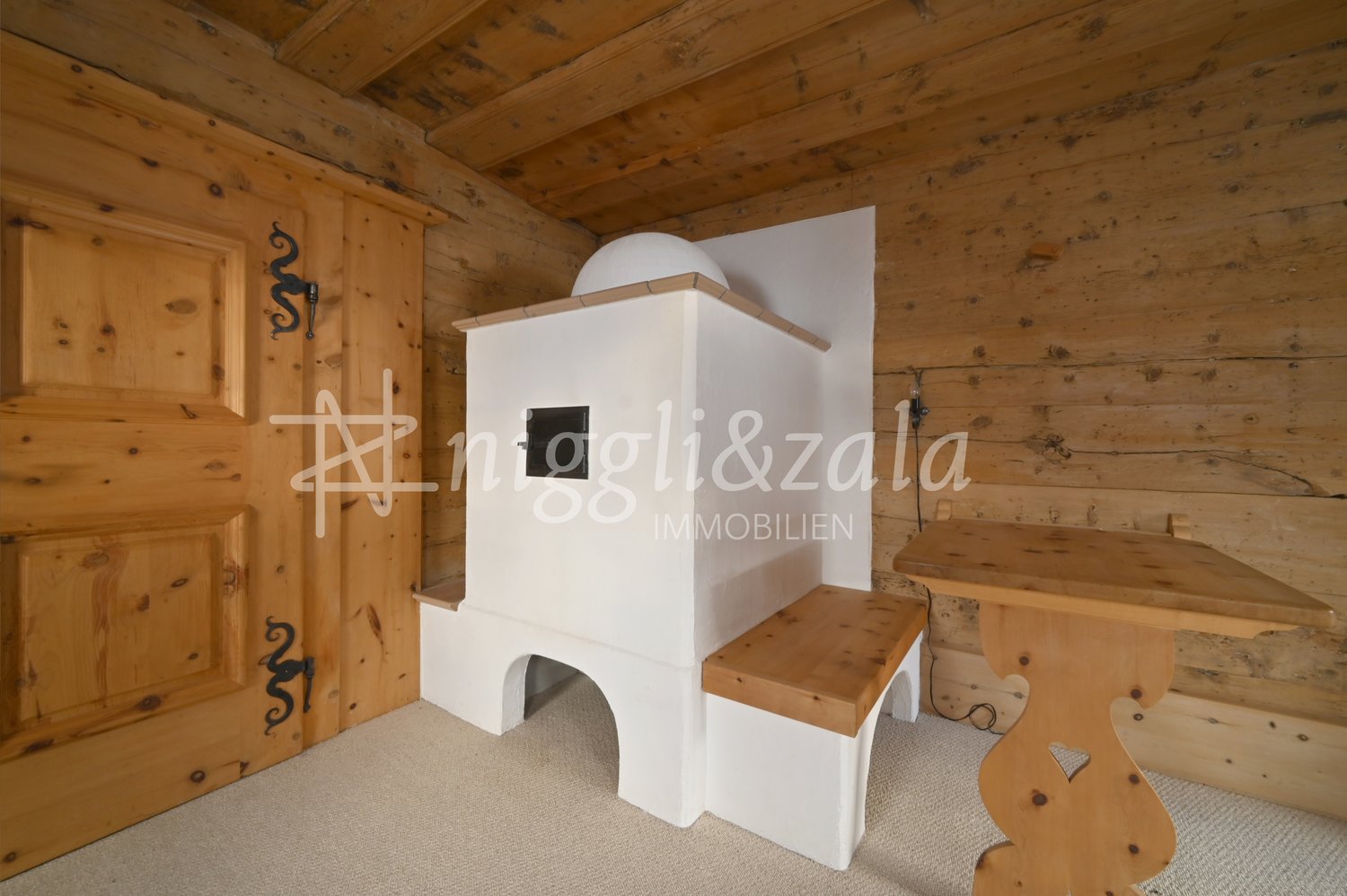 wooden walls, wooden door, white fireplace, wooden bench, wooden table