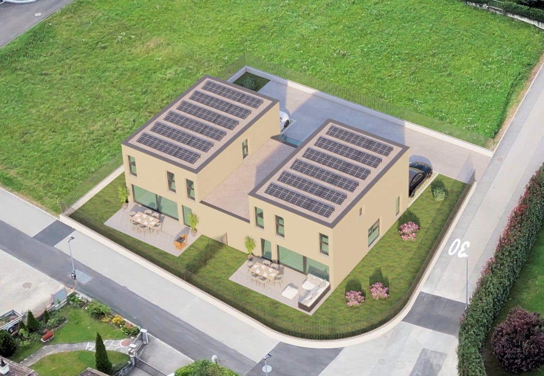 Two story building with solar panels on the roof, car park and seating area