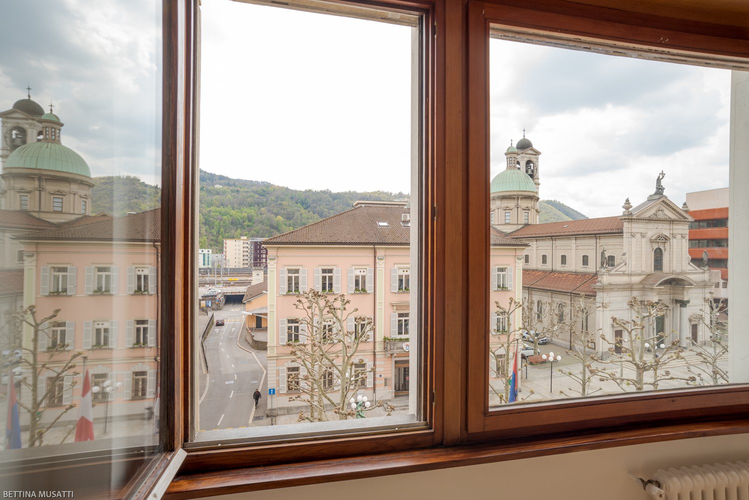 View from the window to the outside buildings and a road, a person walking