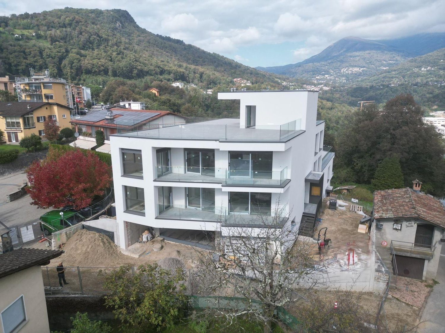 white modern house, 3 levels, multiple balconies, under construction