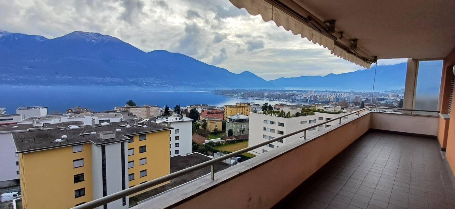 Balcony, tiled floor, railing, surrounding buildings, city view, lake view, mountain view