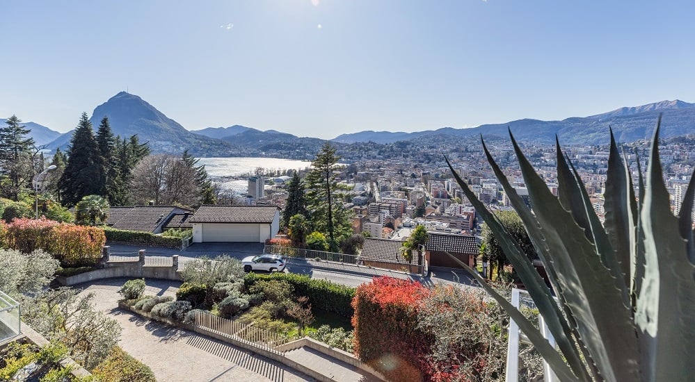 House with garage, driveway, garden, view of mountains and city