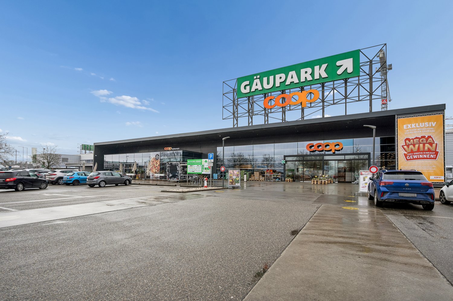 COOP supermarket, modern building, parking lot, advertising signs