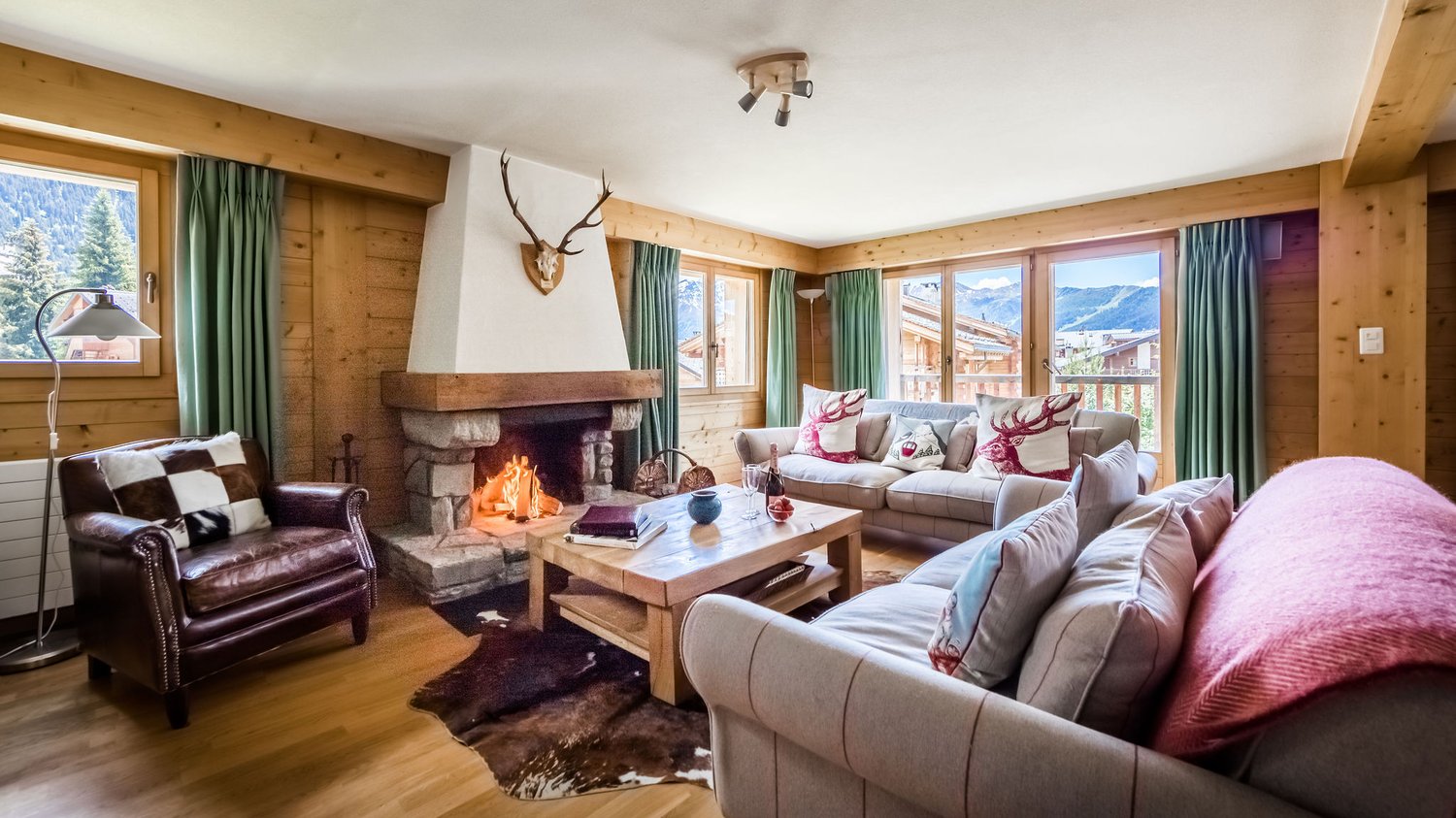 wooden interior, fireplace, carpet, lamp, two couches, center table