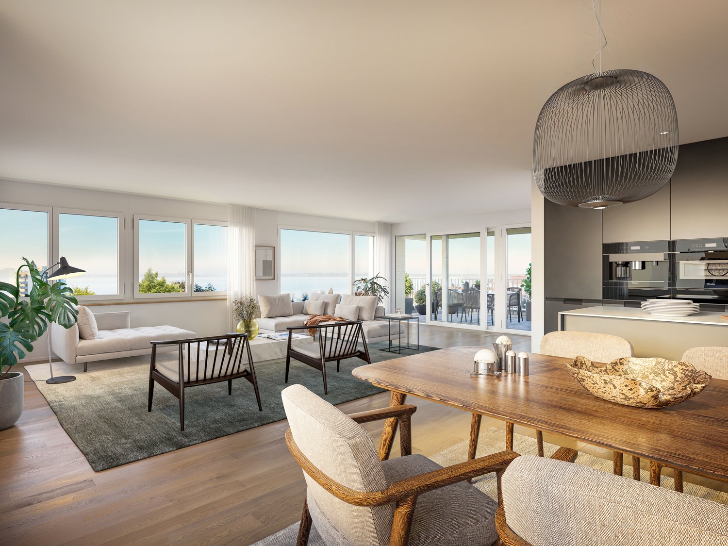 Spacious open-plan living and dining area with large windows offering a scenic view. The living room features a comfortable sofa and armchairs, while the dining area has a wooden dining table and chairs. The kitchen is visible in the background with moder