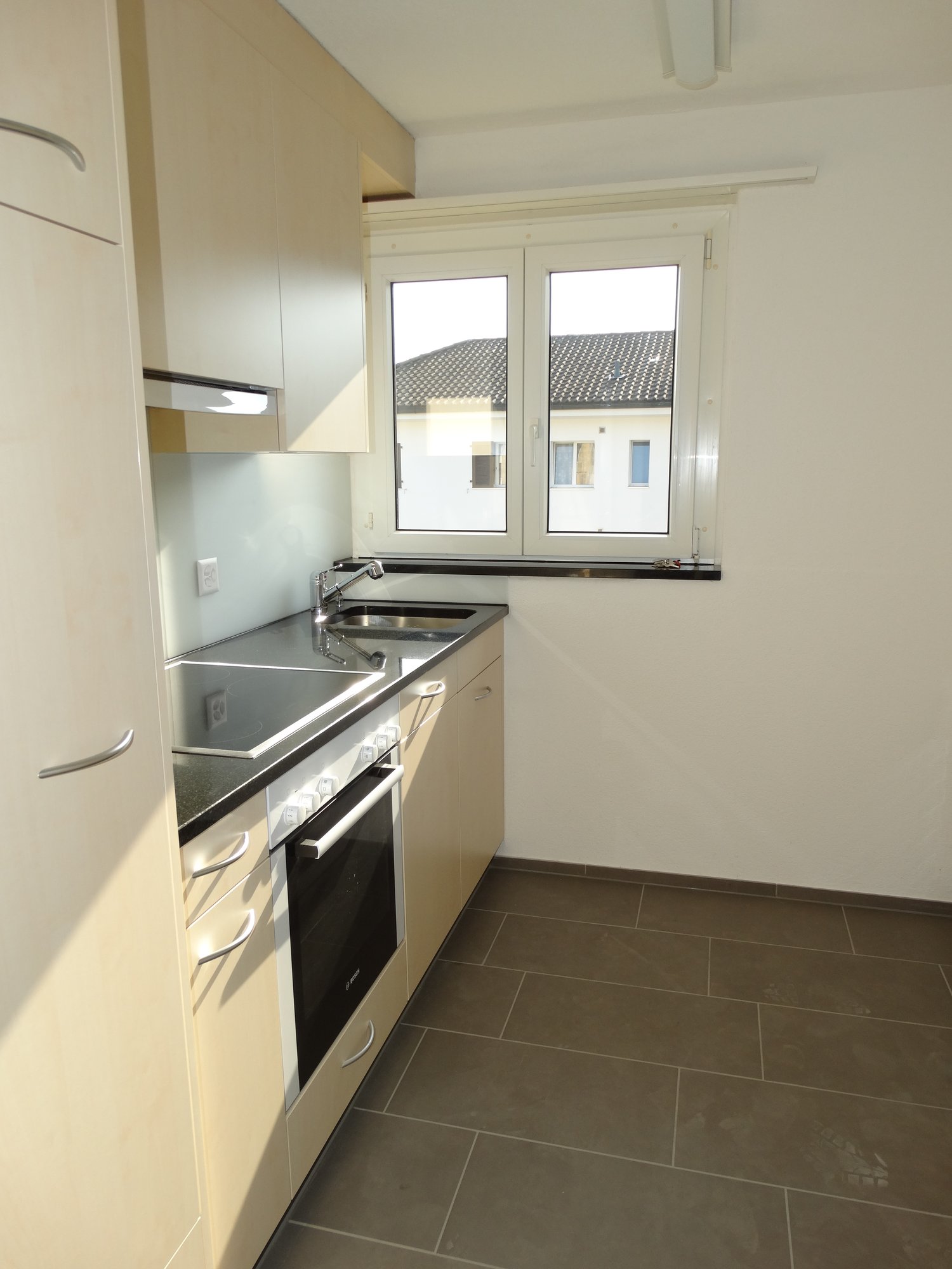 kitchen, tiled floor, wooden cabinets, built-in oven, sink, faucet, window