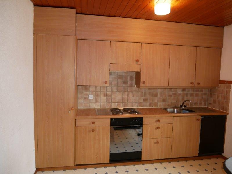 small kitchen, wooden cabinets, gas stove, oven, sink, dishwasher