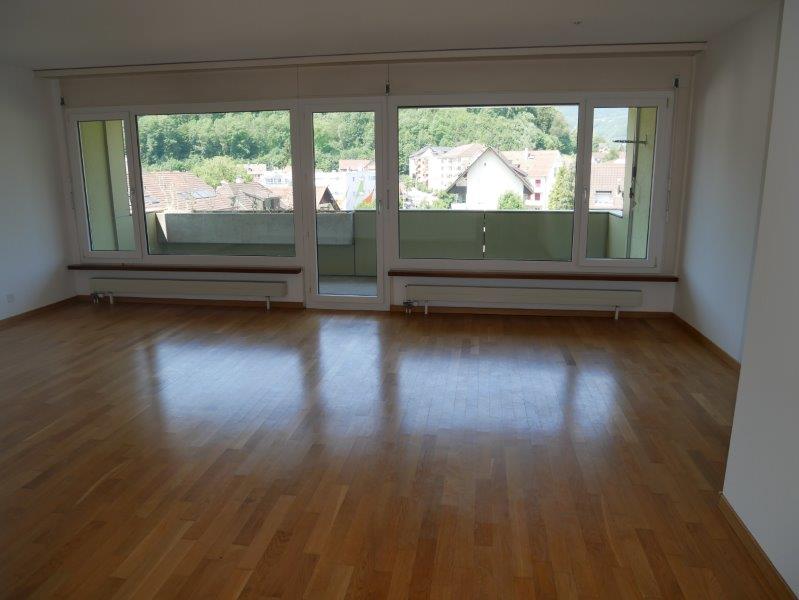 empty room, wooden floor, large windows, balcony, view of the mountains