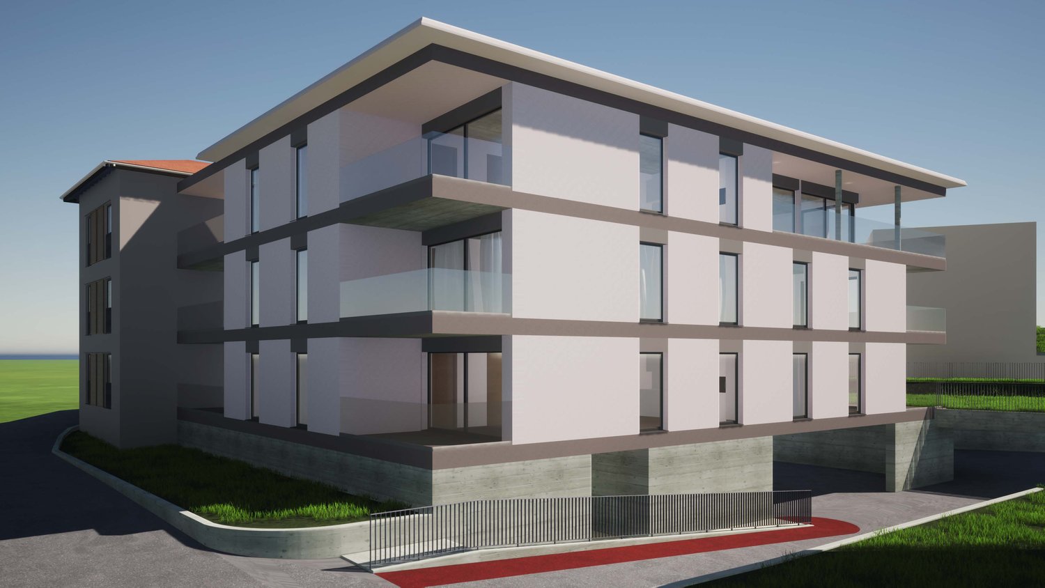 3-story modern apartment building with a flat roof, large windows, and a balcony on the upper floors. The building has a clean, minimalist design with a combination of light and dark colors.