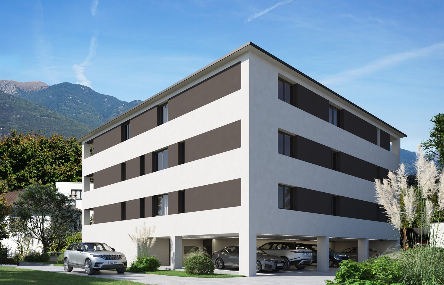 3-story modern apartment building with a flat roof, white and gray exterior, large windows, and a ground-level parking garage with spaces for multiple vehicles.