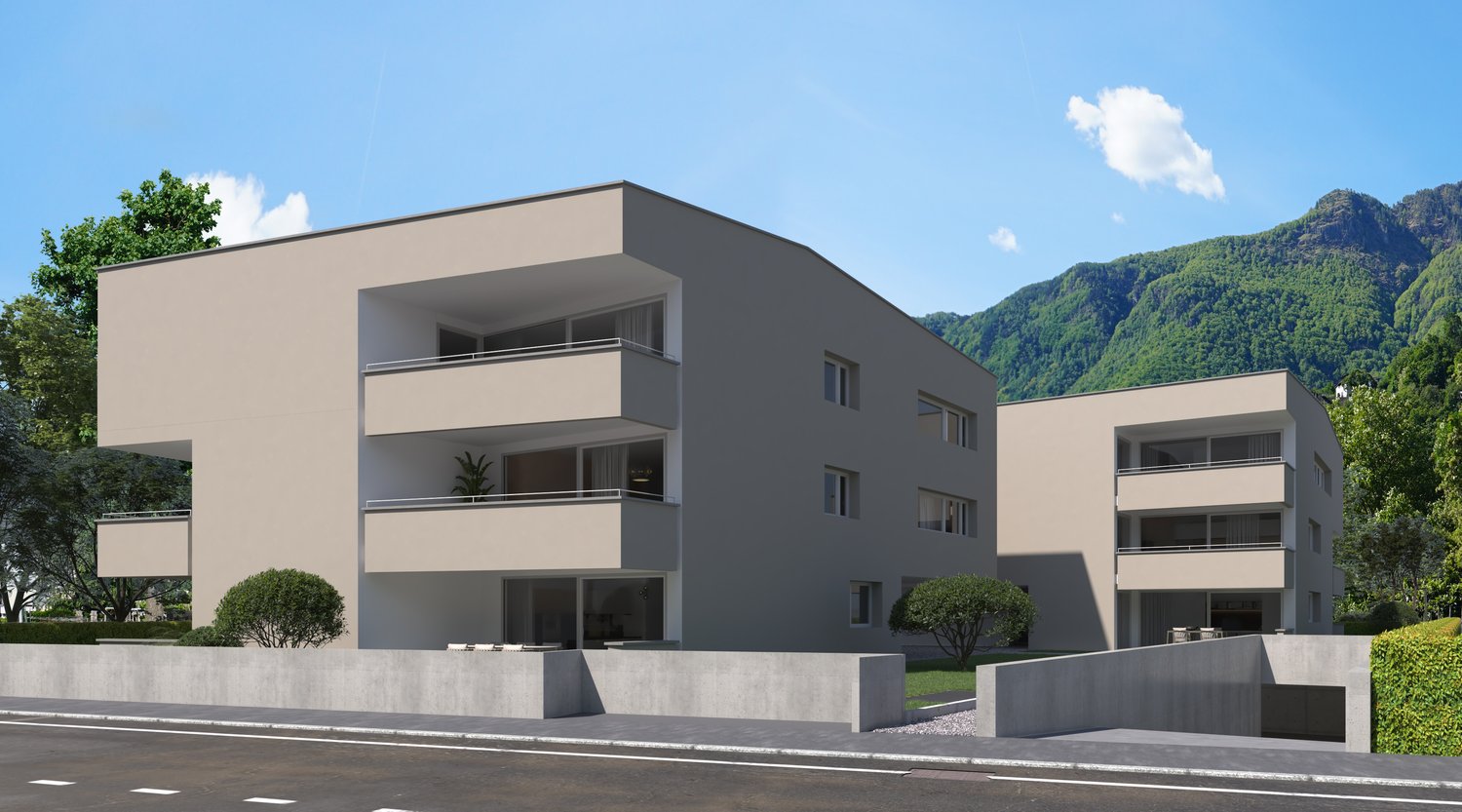 3-story modern apartment building with beige exterior, balconies, and surrounded by trees and mountains in the background.