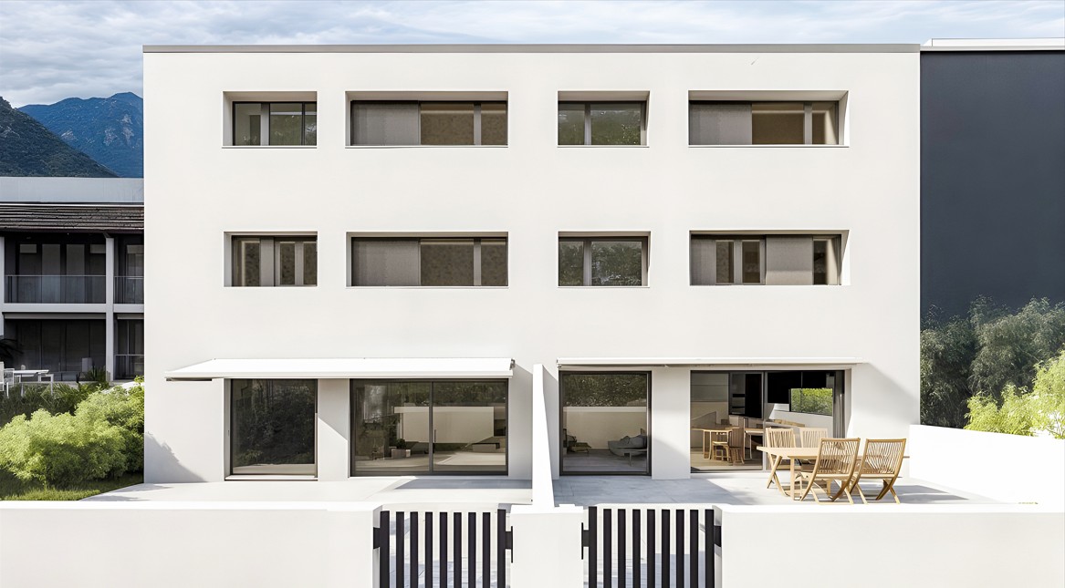 white modern house, large windows, multiple balconies, outdoor seating