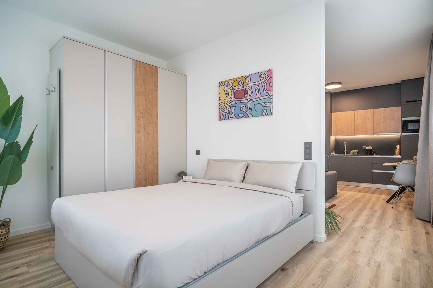 Bedroom with bed, wardrobe, and a small kitchen area