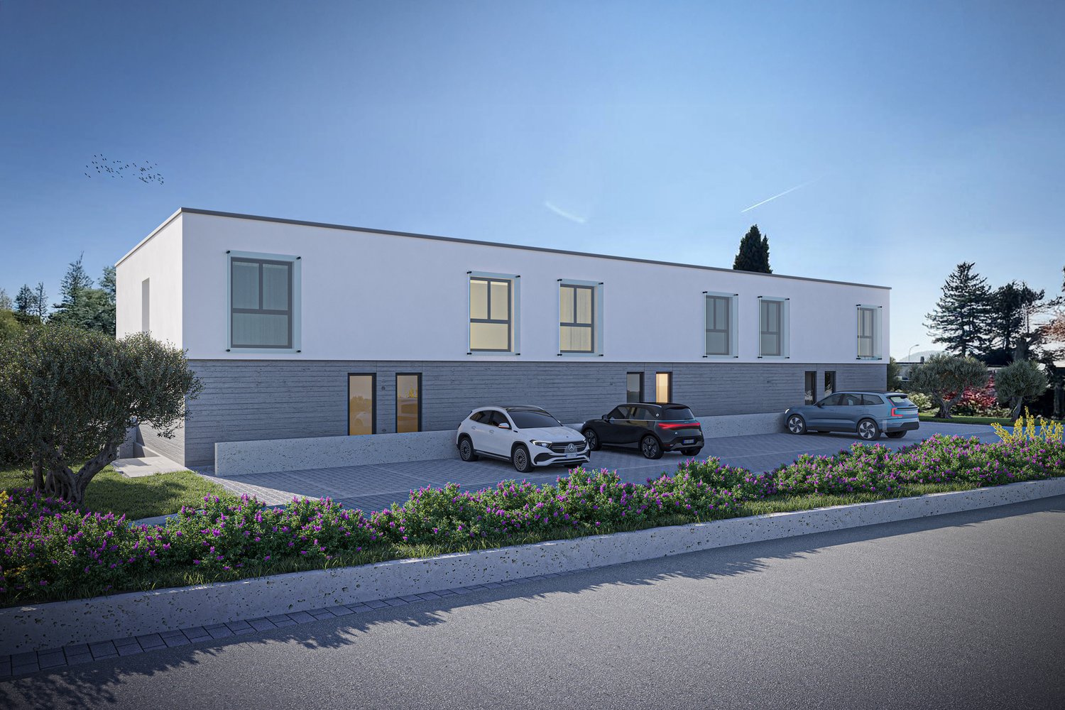 modern 2-story building, white exterior, gray accent, large windows, driveway with three cars parked, surrounding landscaping