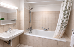 Bathroom with bathtub, sink, mirror, shower curtain, towel rack