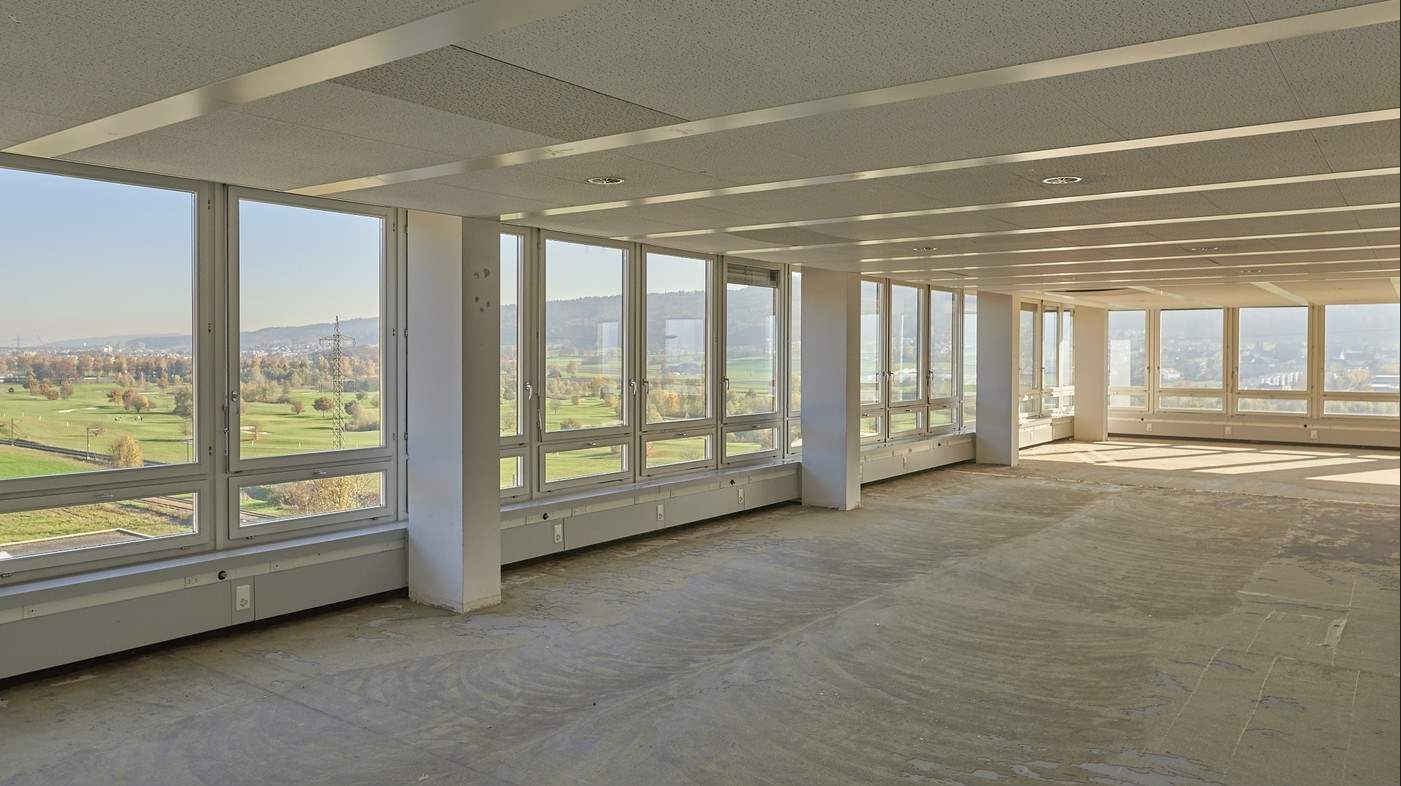 Empty room, large windows, overlooking a golf course