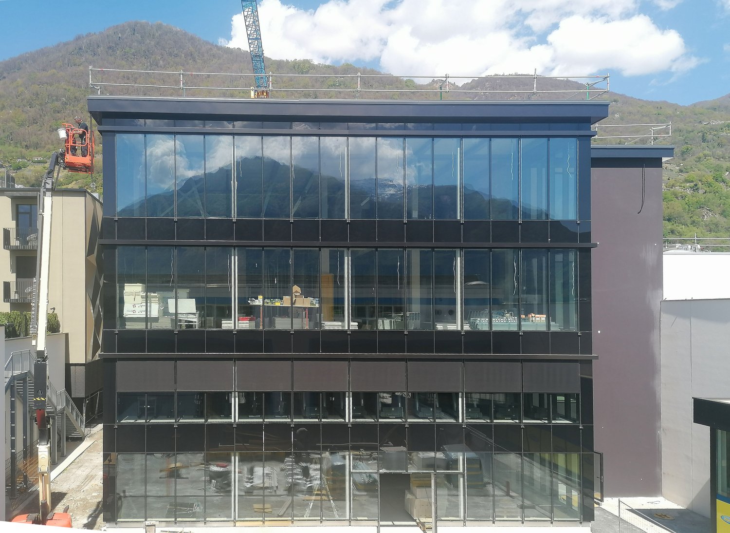 modern office building, glass facade, multiple floors, construction site
