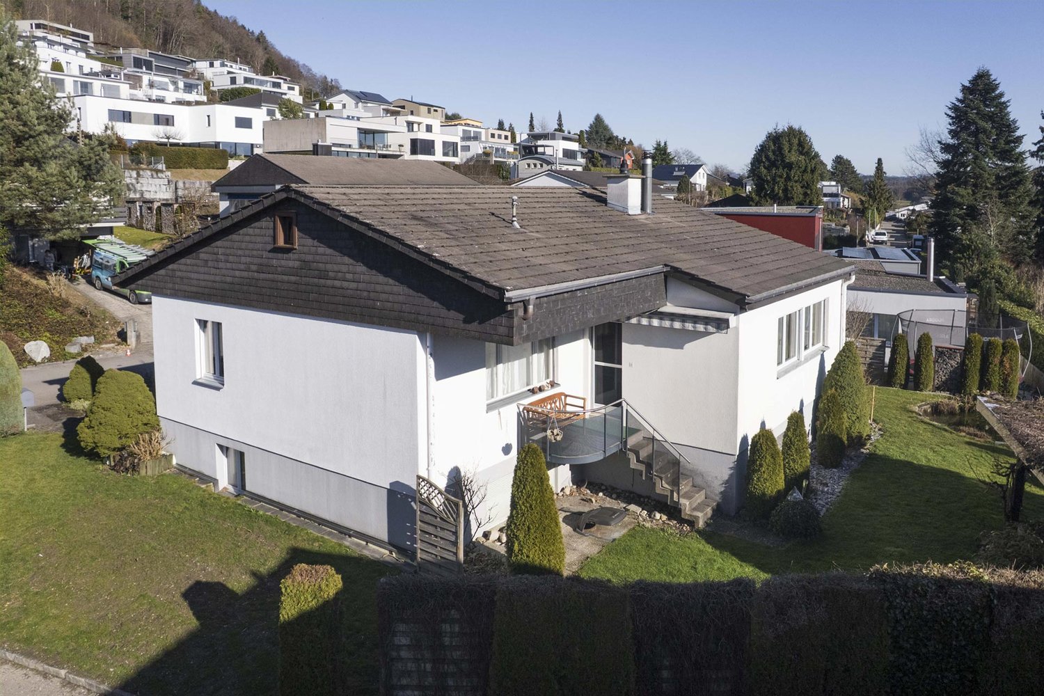 single family house, 2 stories, white walls, gray roof, concrete stairs, balcony with railings