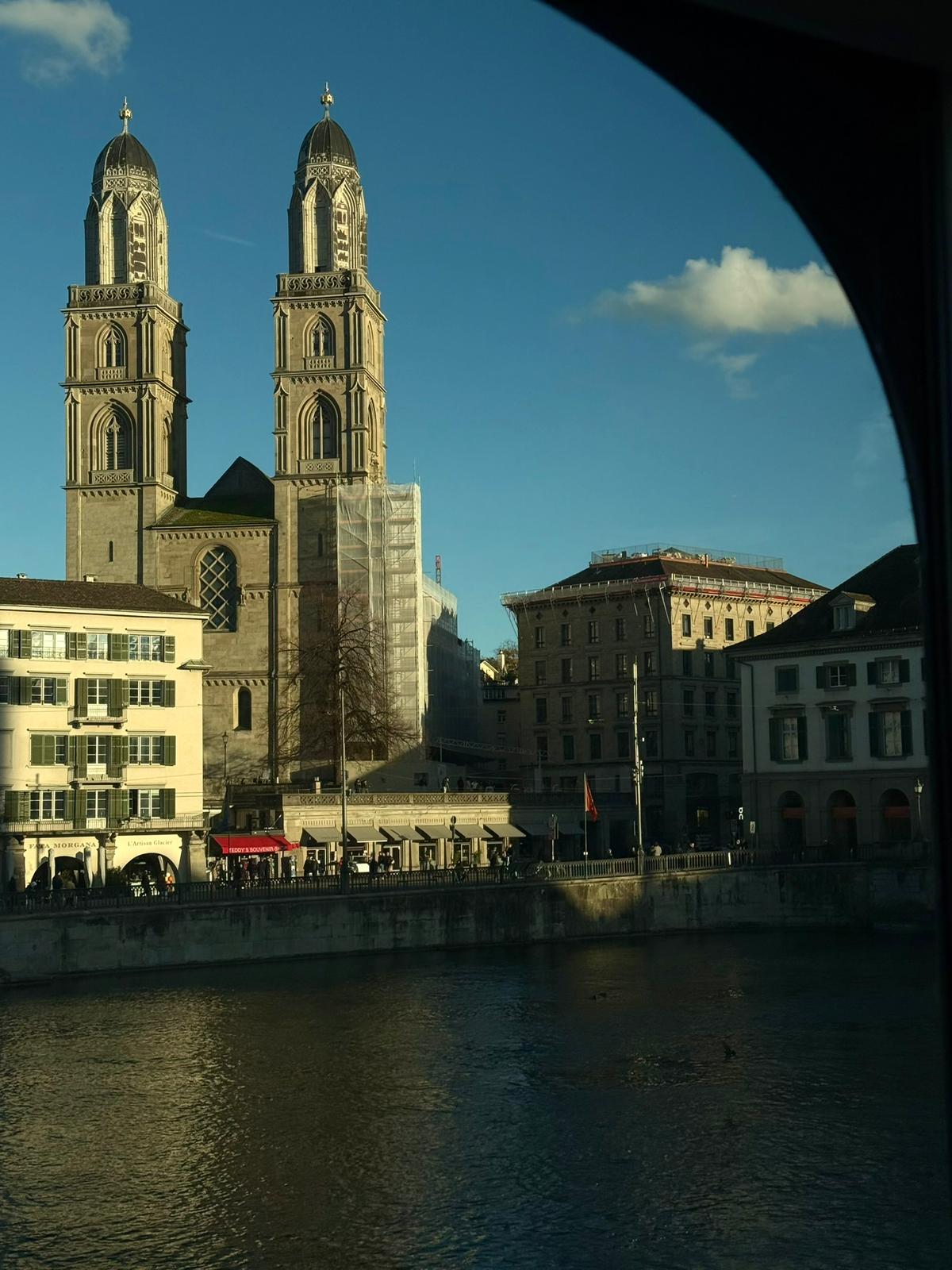 View of a city with a large church, buildings, and a river