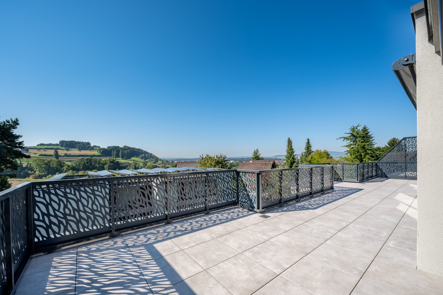 Tiled flooring, metal railings, overlooking the landscape