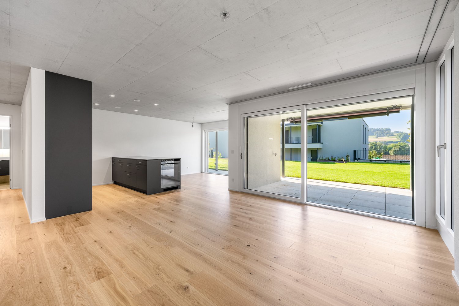 large open space, hardwood floors, sliding glass doors, outdoor terrace, contemporary kitchen