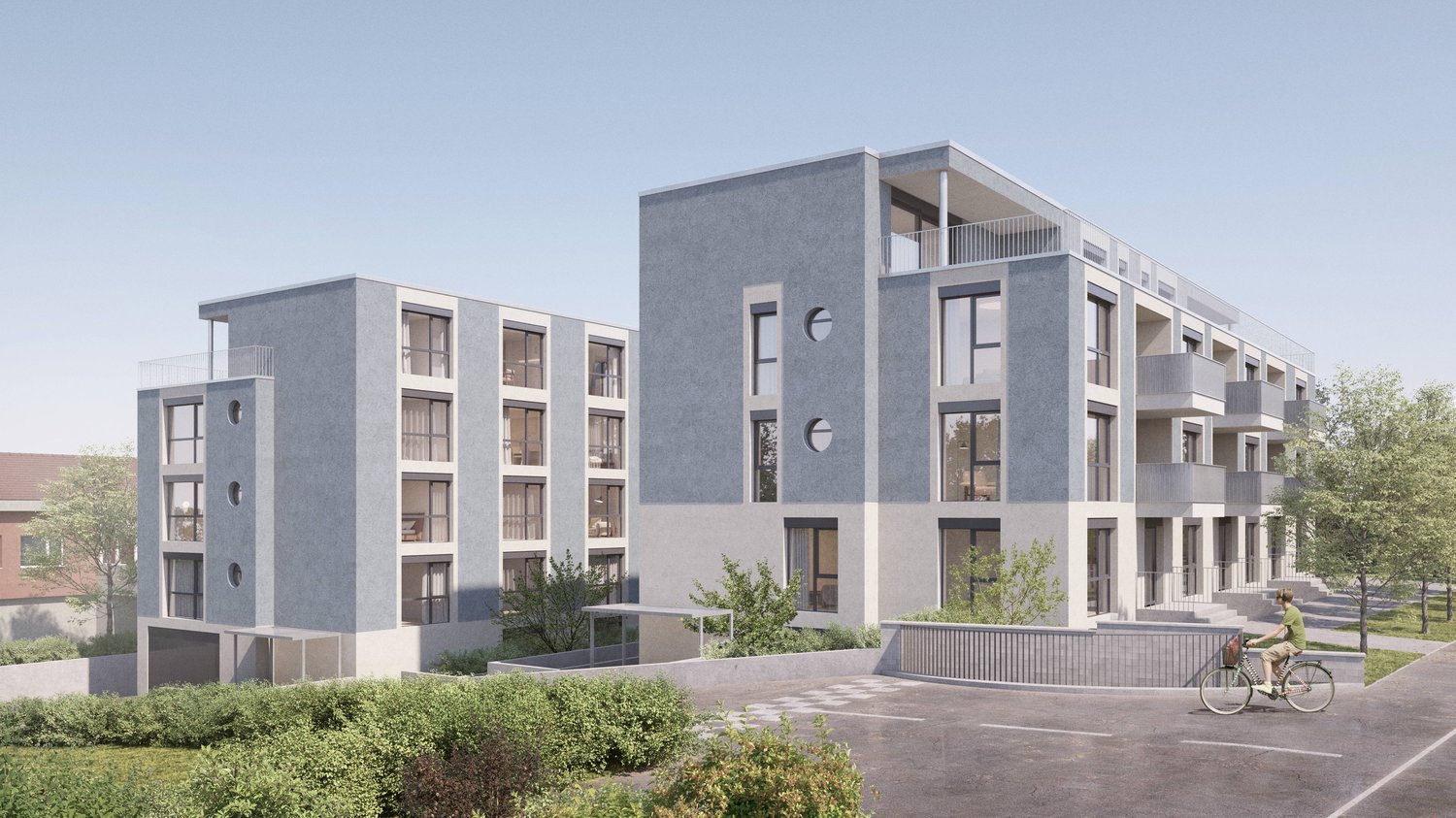 2 story building, grey concrete exterior, many round windows, 2 balconies