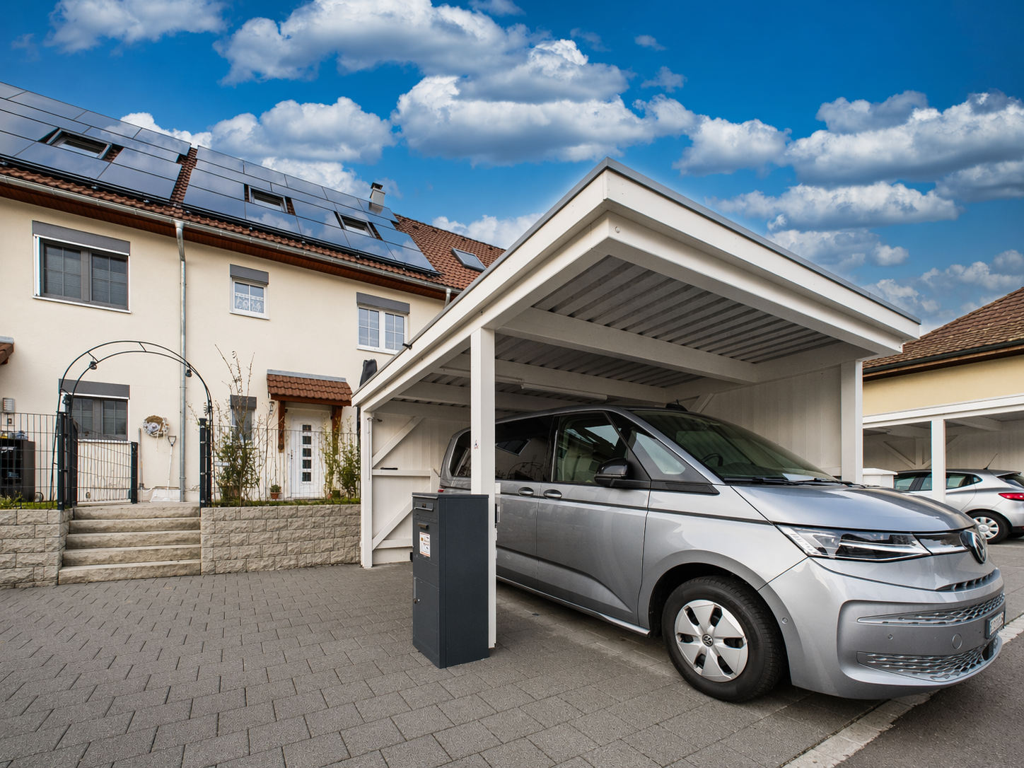 House with solar panels, carport, and a silver car parked under it