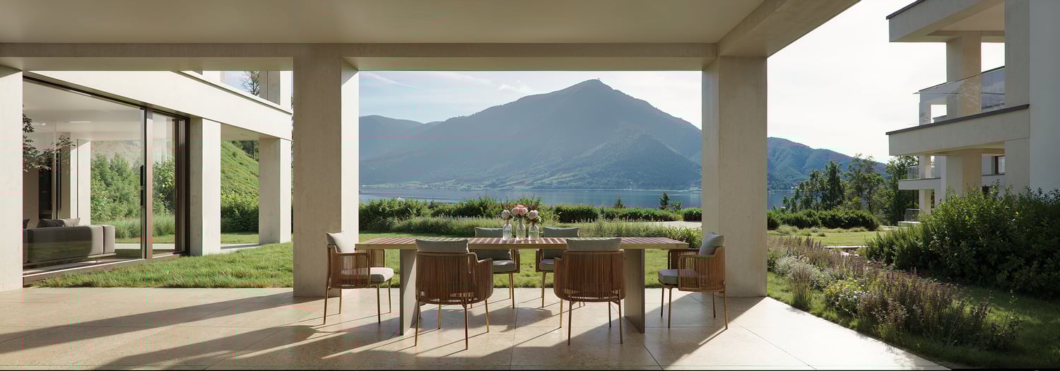 Terrace with modern dining table and chairs, flowers in vases, lake and mountains view