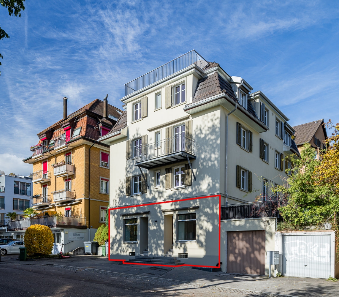 4 story building, cream exterior, red line marks out ground floor apartment for sale