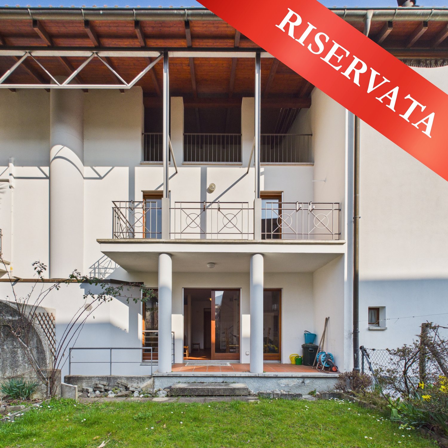 2 story house, white exterior, balcony, large windows, entrance with double doors