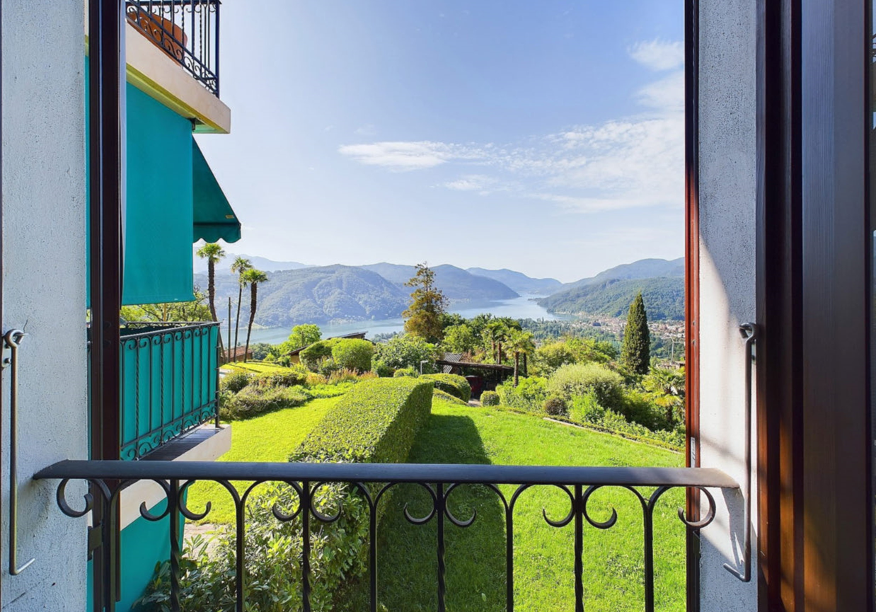 balcony with railings, view of a lake and mountains