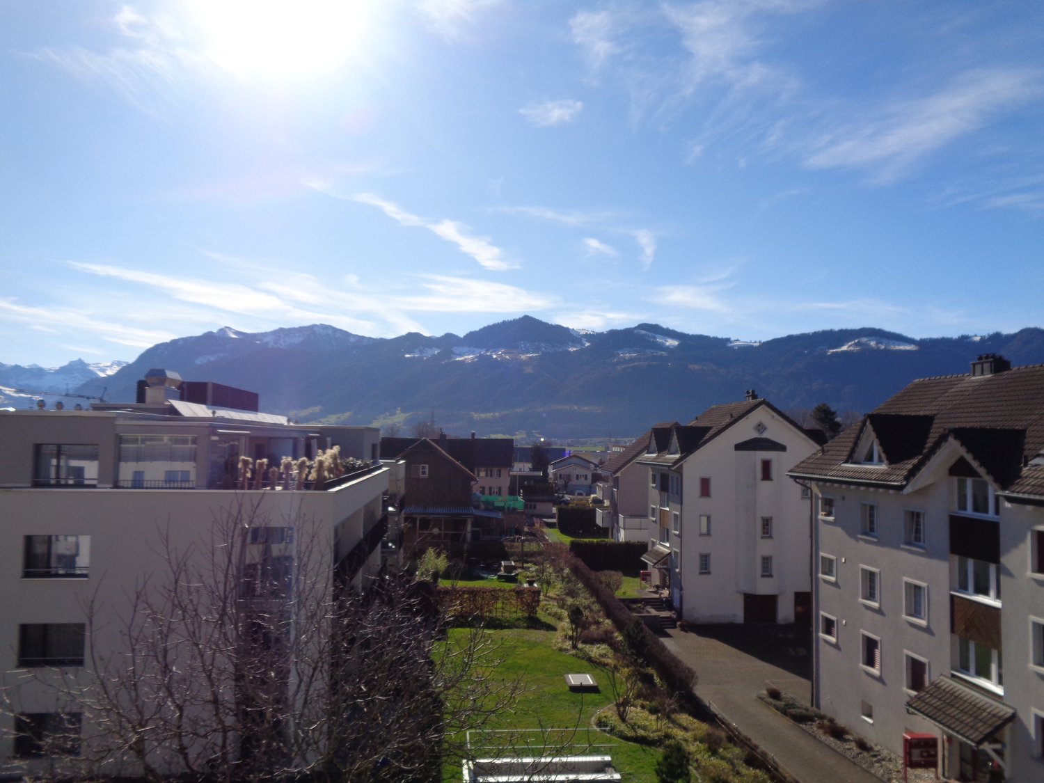 The exterior view of buildings with a beautiful mountain backdrop.