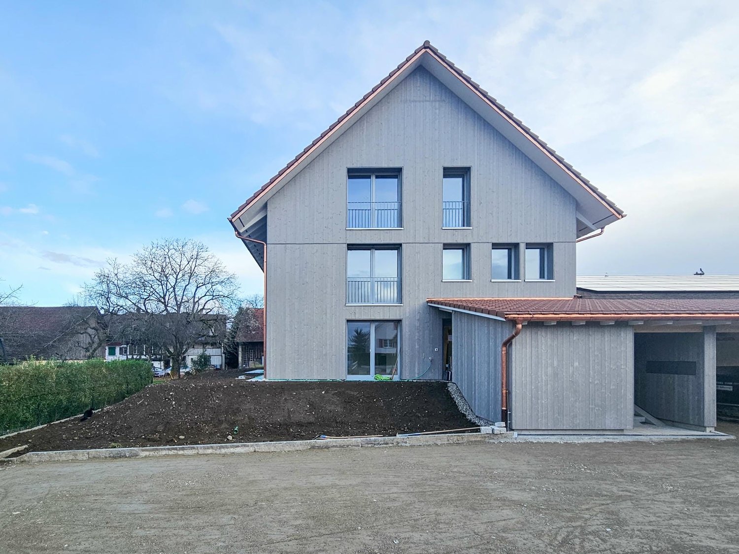 modern house, gray exterior, red roof, large windows, attached garage