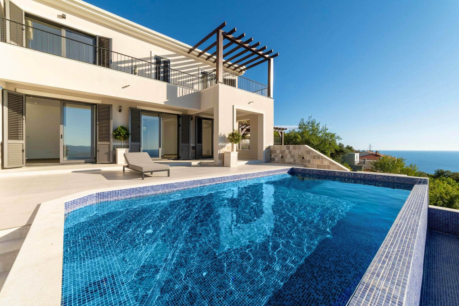 Modern villa, large windows, outdoor seating, pool, wooden pergola, large terrace