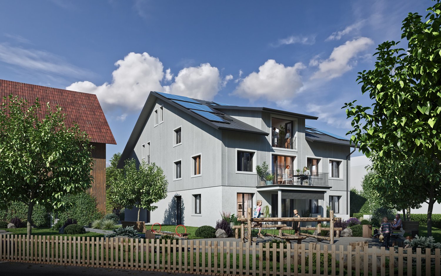 Two-story house, gray exterior, red roof, solar panels on the roof, fenced yard with plants, children playing, balcony with seating on the second floor, fence in front, blue sky with clouds