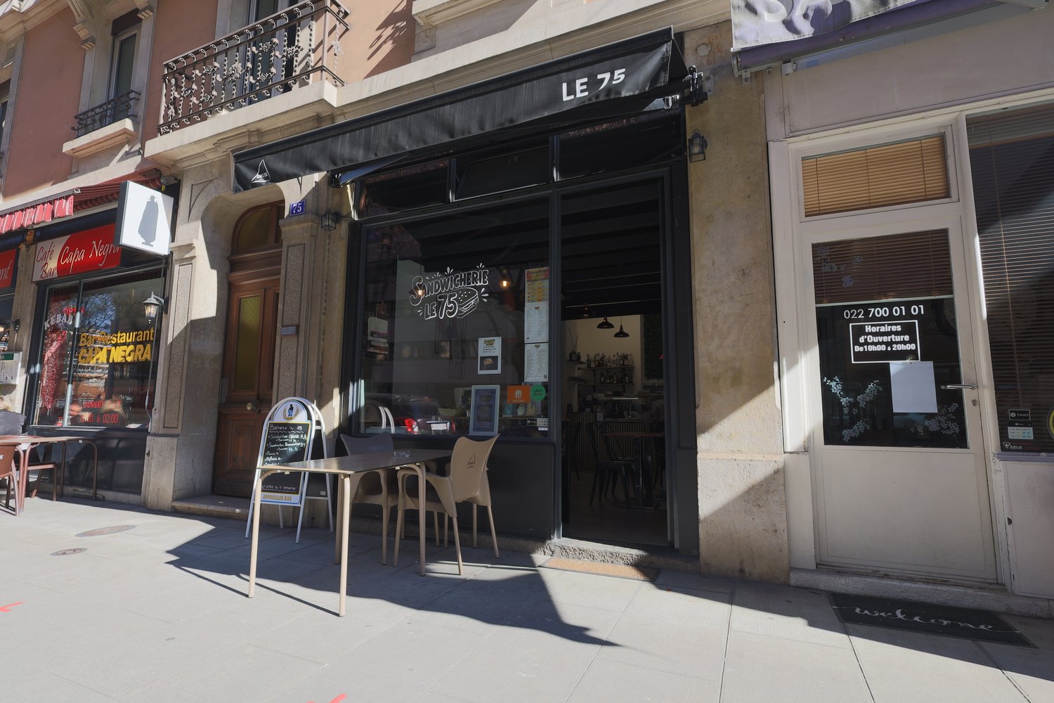 Two restaurants, one has a blackboard menu on the entrance