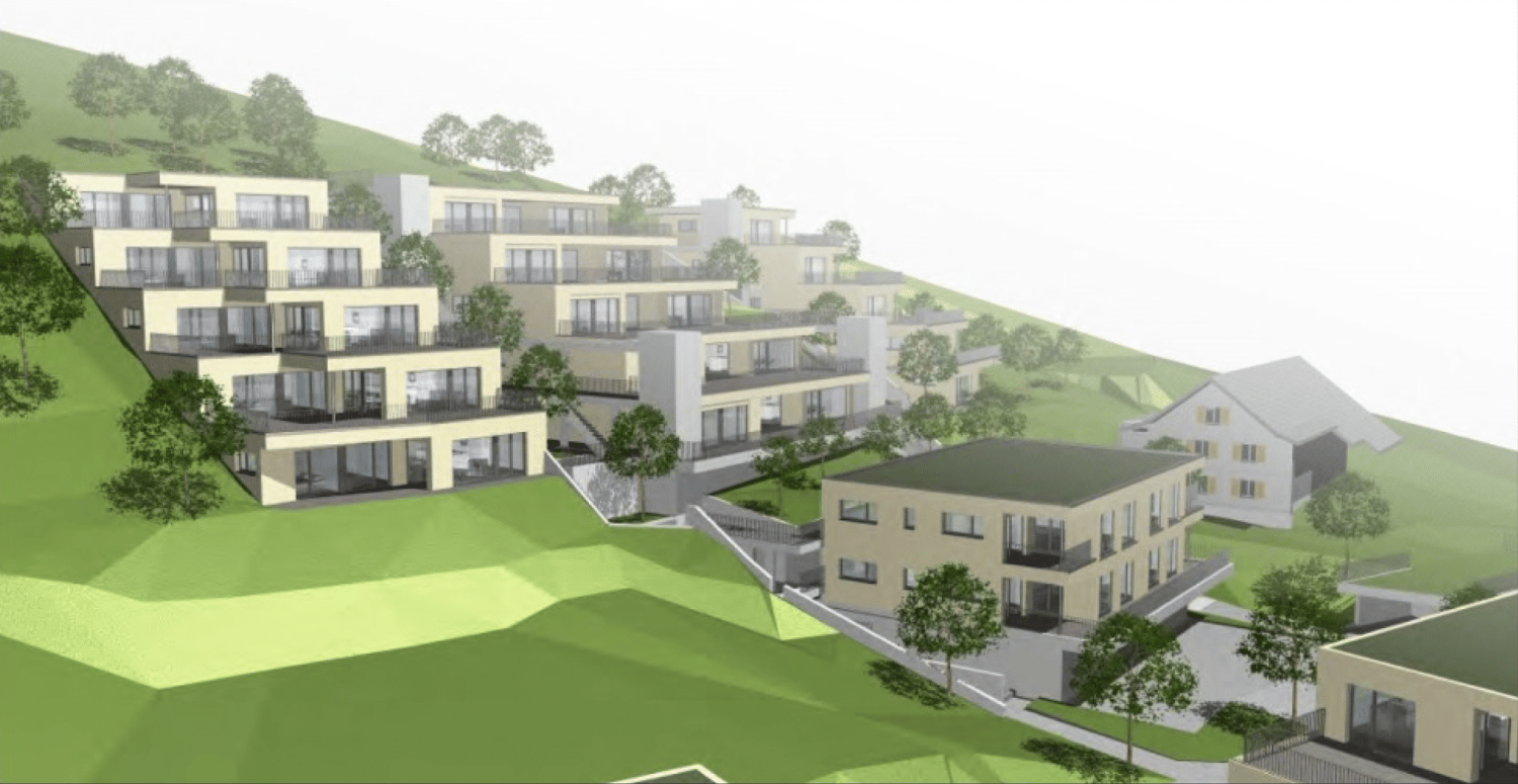 Aerial view of a residential building complex with multiple buildings, balconies, and green spaces
