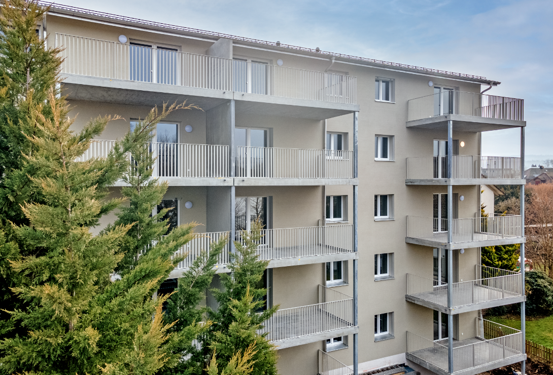 Multi-storey building, balconies, white exterior, modern design, trees in front