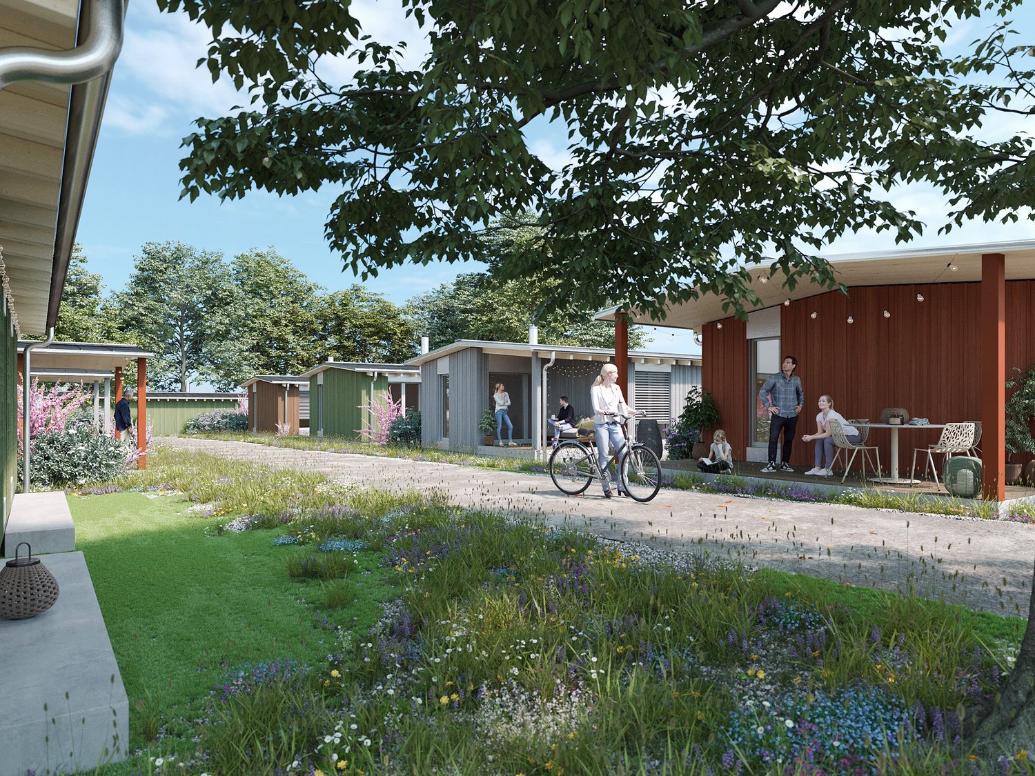 Modern homes with green exterior, garden with flowers, paved pathway, people with bicycles and chairs