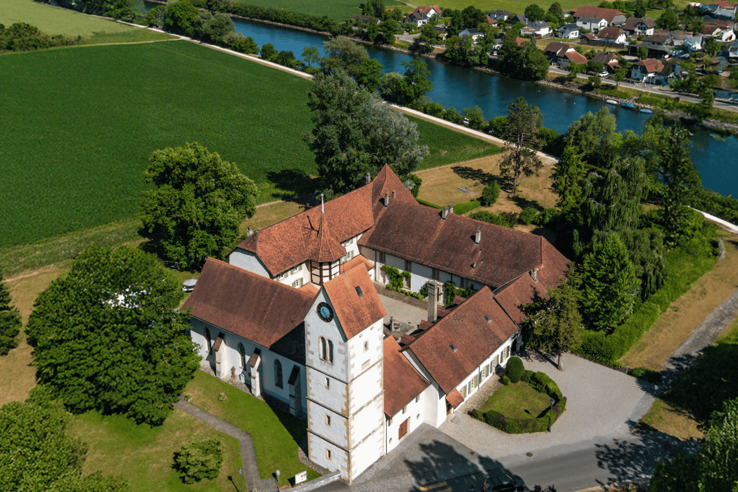 Historic building, large, brick walls, steeple, clock, windows, large garden, large driveway