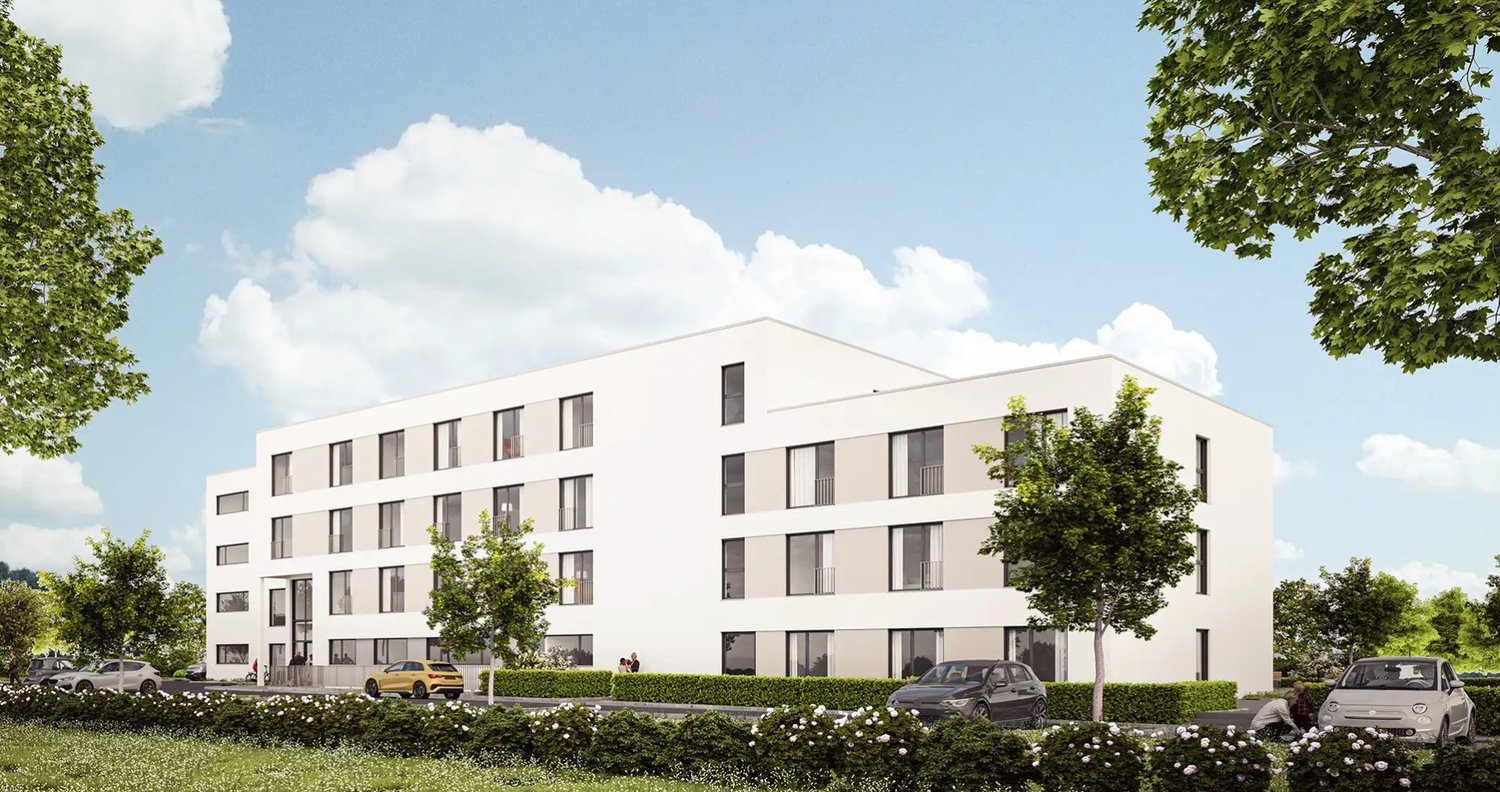 4 story white building, many windows, balconies, parking area, trees, bushes, cars parked