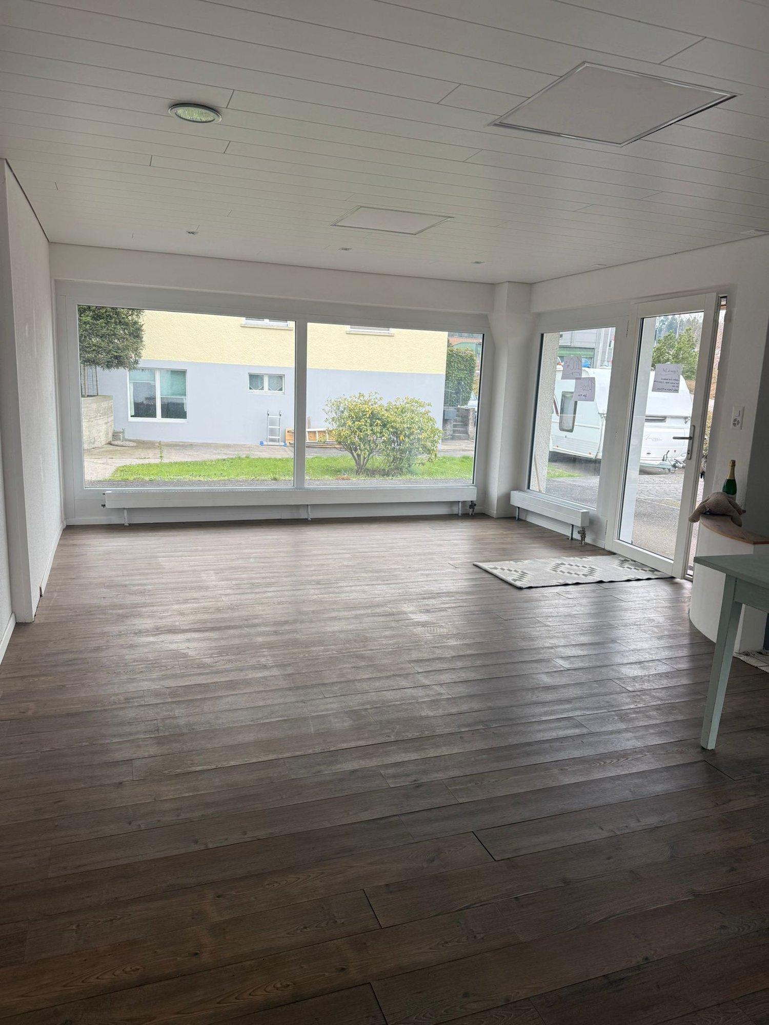 large windows, wooden floor, white walls, empty room