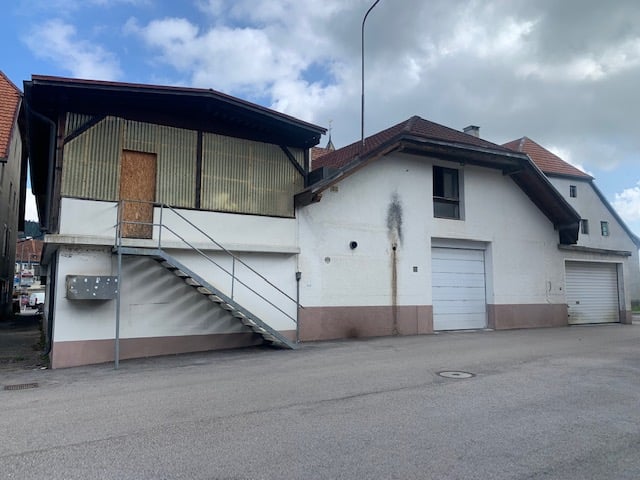 2 story building, white and brown walls, 2 garages, stairs