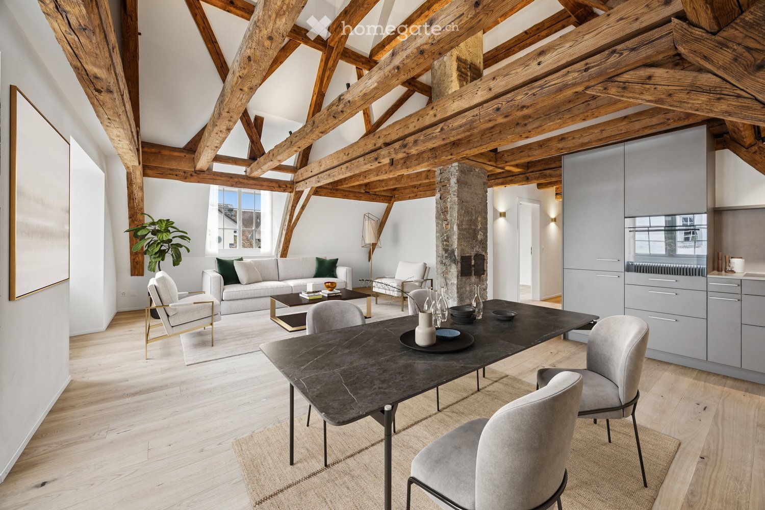 open space with large wooden beams, dining table with chairs, couch with coffee table, side table, rug, potted plant, kitchen area