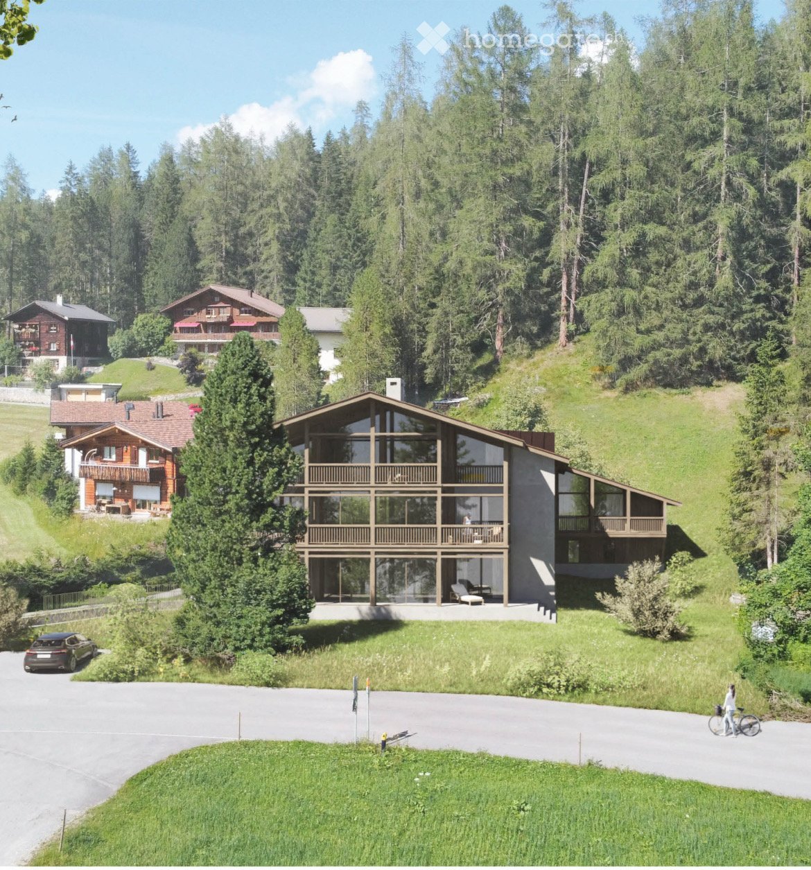 Large modern chalet-style house with multiple balconies and terraces, surrounded by a forested area with other smaller buildings in the background.