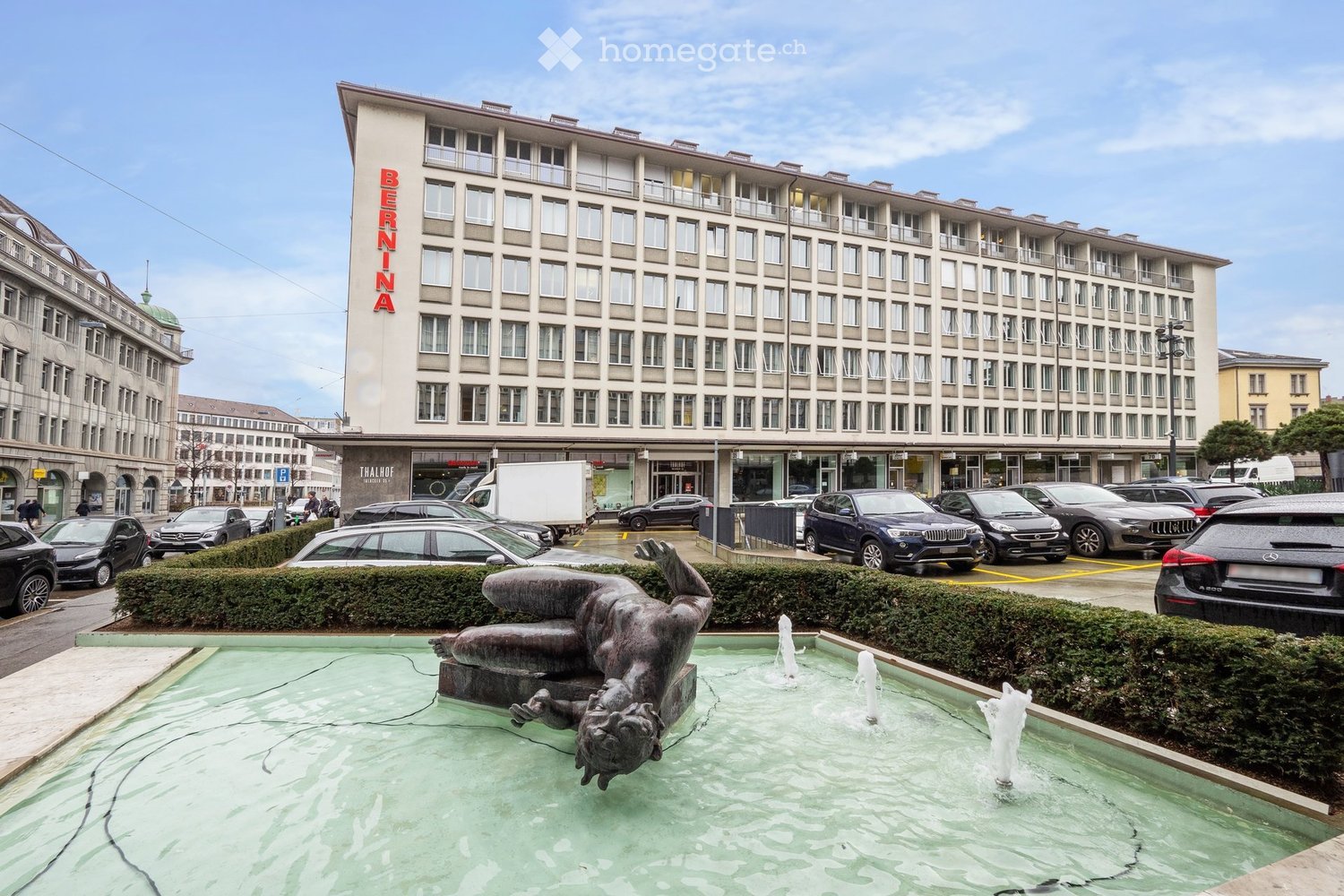 Thalhof hotel, front view, large hotel, several floors, fountain, sculpture, many cars parked